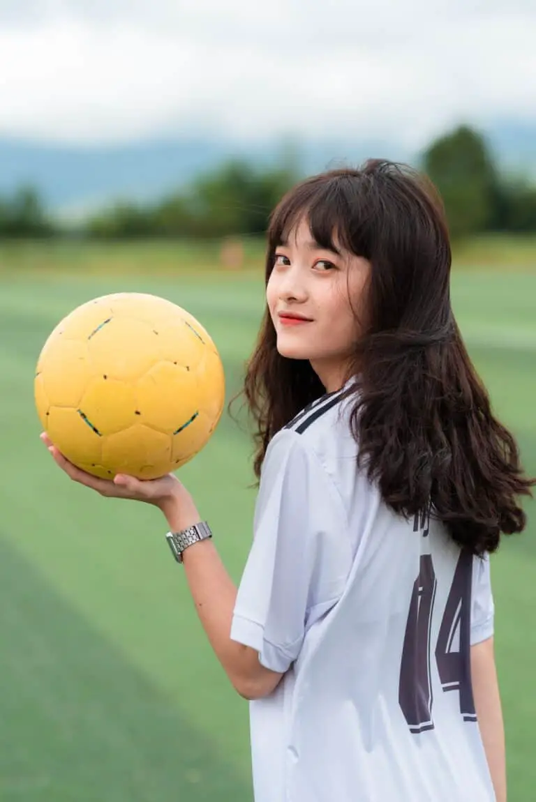 Girl with soccer ball in her hand